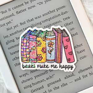May include: A sticker with a stack of colorful books with glitter and the text "books make me happy".