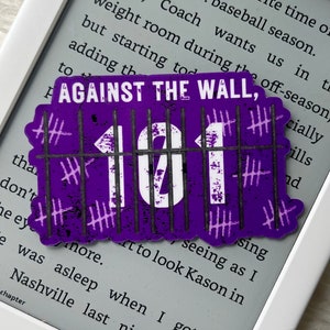 May include: Purple sticker with the text "AGAINST THE WALL, 101" in white lettering. The sticker has a jail cell design with hash marks on the bars.