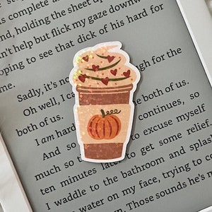 May include: A close-up of a sticker featuring a brown and white coffee cup with a pumpkin and hearts on it. The sticker is on a gray background with text that reads "Sadly, it's no Oh well, I ca both of us. I am hard And so much so t ten minutes late to get some relief. I waddle to the bathroom and splas some water on my face, trying to co my body down. Those sounds he's m"
