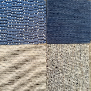 May include: Four fabric swatches in shades of blue, gray, and white. The top left swatch has a textured pattern with white accents. The top right is a solid navy blue. The bottom left is striped, and the bottom right has a speckled appearance.