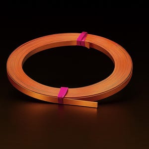 May include: A coil of orange-colored craft paper, bound with two magenta bands. The paper is tightly wound, creating a circular shape against a dark background. The paper appears to be thin and flexible.