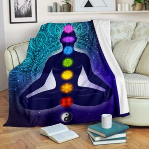 May include: A blue and purple fleece throw blanket with a mandala pattern and a silhouette of a person in a yoga pose with seven chakras. The chakras are represented by colorful circles.