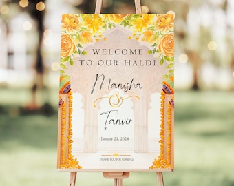May include: Welcome to our Haldi sign with a floral design and an archway. The sign features the names Manisha & Tanvir and the date January 21, 2024. The sign also includes the text "Thank you for coming."