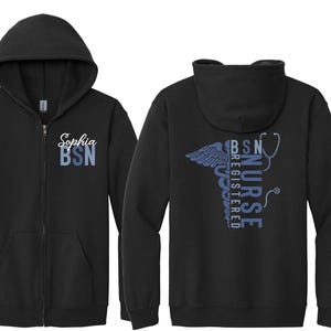 May include: A black zip-up hoodie featuring a hood and front pockets. The left chest displays the white script name Sophia above the blue text BSN. The back features a blue caduceus, a stethoscope, and the vertical text REGISTERED NURSE BSN.