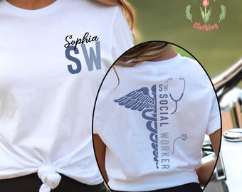 May include: White t-shirt with the name "Sophia" and "SW" in blue. The back of the shirt features a caduceus design with the words "Social Worker" and a stethoscope. The shirt is from Red Tulip Clothing.