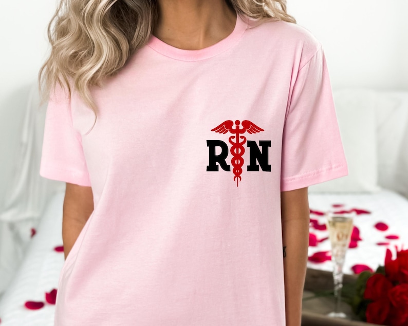 May include: Pink t-shirt with a black "RN" graphic and a red medical symbol.