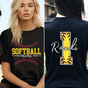 May include: Two black t-shirts with a softball theme. One shirt has the text "SOFTBALL mimi" with a red and white baseball stitch design. The other shirt has a large yellow number "1" with red stitching and the name "Randi" in white cursive writing.