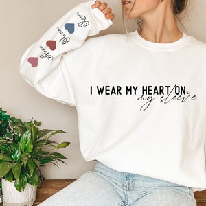 Personalized I Wear My Heart On My Sleeve Sweatshirt, Gift for Mom, Mama Hoodie with Children Name on Sleeve, Mothers Day Gift