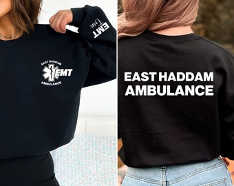 May include: Black sweatshirt with a white graphic of a medical star and the text "East Haddam Ambulance EMT". The back of the sweatshirt has the text "East Haddam Ambulance" in white.