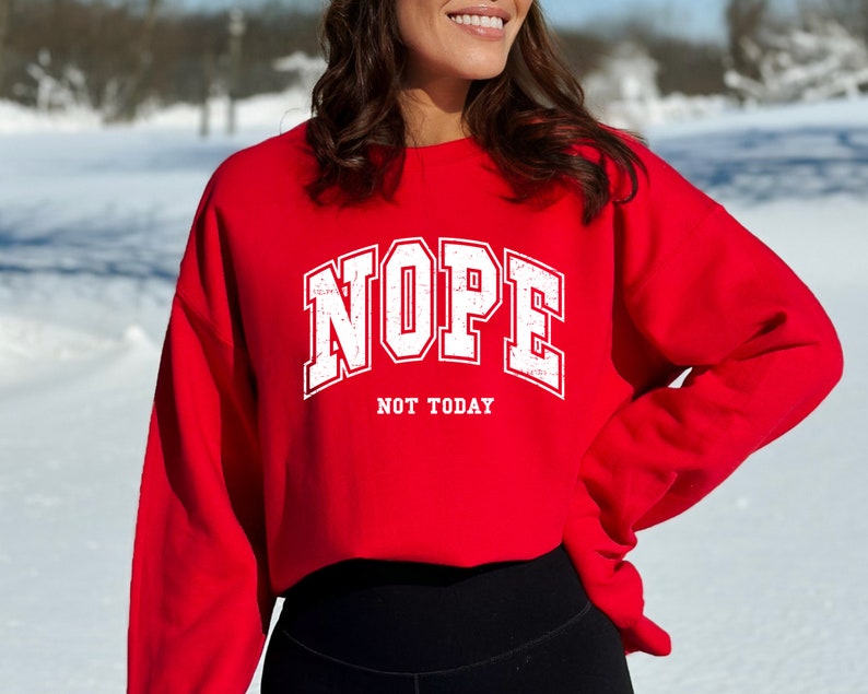 May include: Red cropped sweatshirt with white text that reads "NOPE NOT TODAY".
