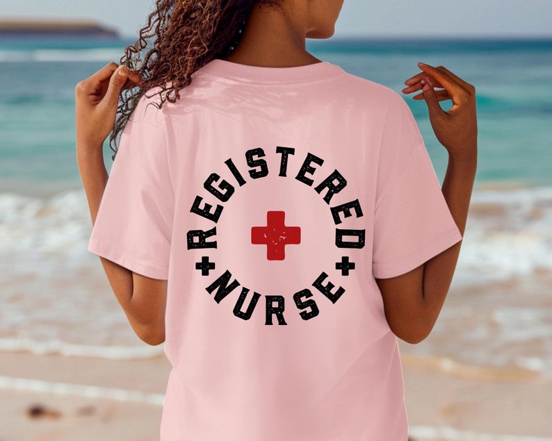 May include: Pink t-shirt with a black and white graphic that says "Registered Nurse" with a red cross in the center.