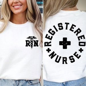 May include: White sweatshirt with a black medical symbol and the letters "RN" on the front. The back of the sweatshirt has a black circle with the words "REGISTERED NURSE" and a black plus sign.