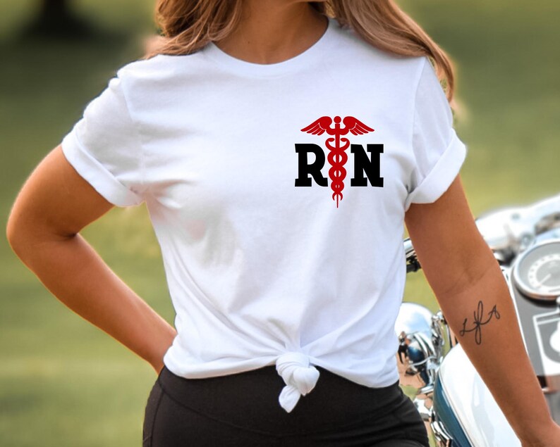 May include: White t-shirt with a red medical symbol and the letters "RN" in black.