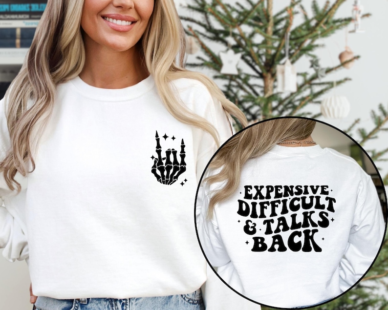 May include: White long-sleeve shirt with a black skeleton hand graphic on the front and the text "EXPENSIVE. DIFFICULT. & TALKS BACK." on the back.