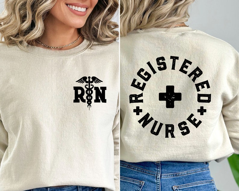 May include: A beige sweatshirt with a black medical symbol and the letters "RN" on the front. The back of the sweatshirt has a black circle with the words "Registered Nurse" in a vintage style font.