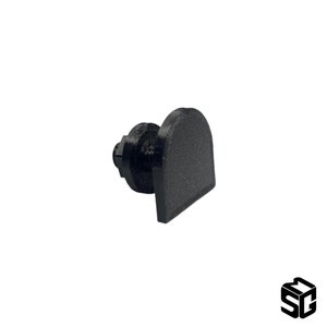 May include: A black plastic push-in fastener with a rounded head. The fastener is designed to be used in automotive applications.