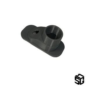 Może przedstawiać: Adapter z tworzywa sztucznego w kolorze szarym, wydrukowany w technologii 3D, z okrągłym otworem i płaską podstawą.