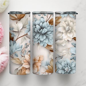 Può includere: Tre bicchieri in acciaio inossidabile con un design floreale. I bicchieri hanno uno sfondo bianco con fiori blu e marroni.
