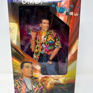 May include: Action figure of a man in a colorful shirt, blue jeans, and a belt, holding a gun. The box reads "Mong Kok C.I.D." and "Wai sir". The figure is a collectible item, with a warning about small parts.
