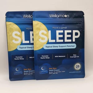 May include: Two blue and yellow pouches of topical sleep support patches with the text "Have a great SLEEP" and "Topical Sleep Support Patches" on the front. The pouches are labeled "Wellamoon" and feature a crescent moon graphic. Each pouch contains 28 patches and includes the text "Promotes Restful Sleep" and "With Melatonin".