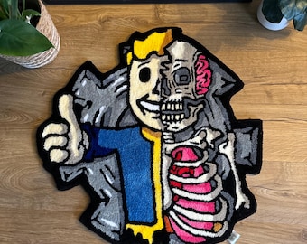 May include: A handmade rug featuring a cartoon character with a half-skeleton design. The rug has a black border, with the character's face, hair, and clothing in yellow, blue, and gray. The skeleton is pink and white.
