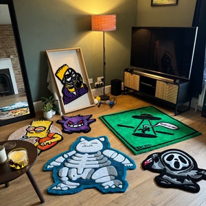 May include: A collection of colorful, cartoon-themed rugs featuring characters like a ghost, a skeleton, and a cartoon character with a yellow hat. The rugs are laid out on a wooden floor in a living room setting.