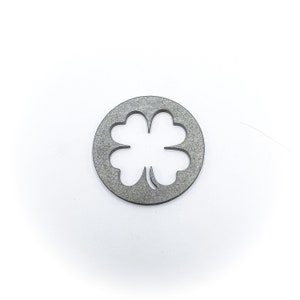 May include: A silver metal charm with a four-leaf clover cutout design.