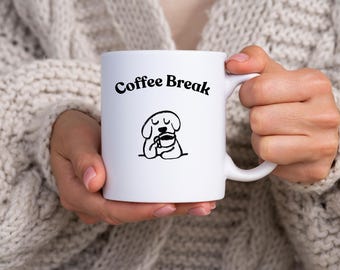 Relax with this cozy mug featuring a cute pup sipping coffee, eyes closed in bliss, and the words Coffee Break to set the mood.