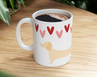 A charming beige dachshund surrounded by a row of red and pink hearts. Sweet, simple, and impossible not to love.