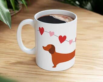 A warm brown dachshund nestled among a string of red and pink hearts. Cozy, sweet, and made for your favorite moments.
