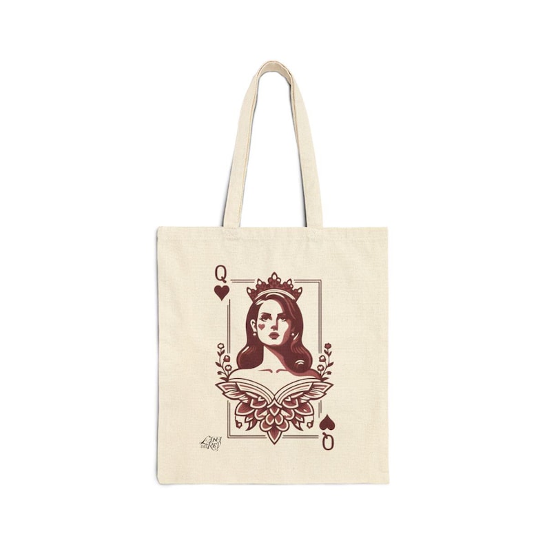 May include: Cream-colored tote bag featuring a maroon illustration of a queen from a deck of cards. The design includes a portrait of a woman wearing a crown, framed by floral elements and the letter "Q" with heart suit symbols.