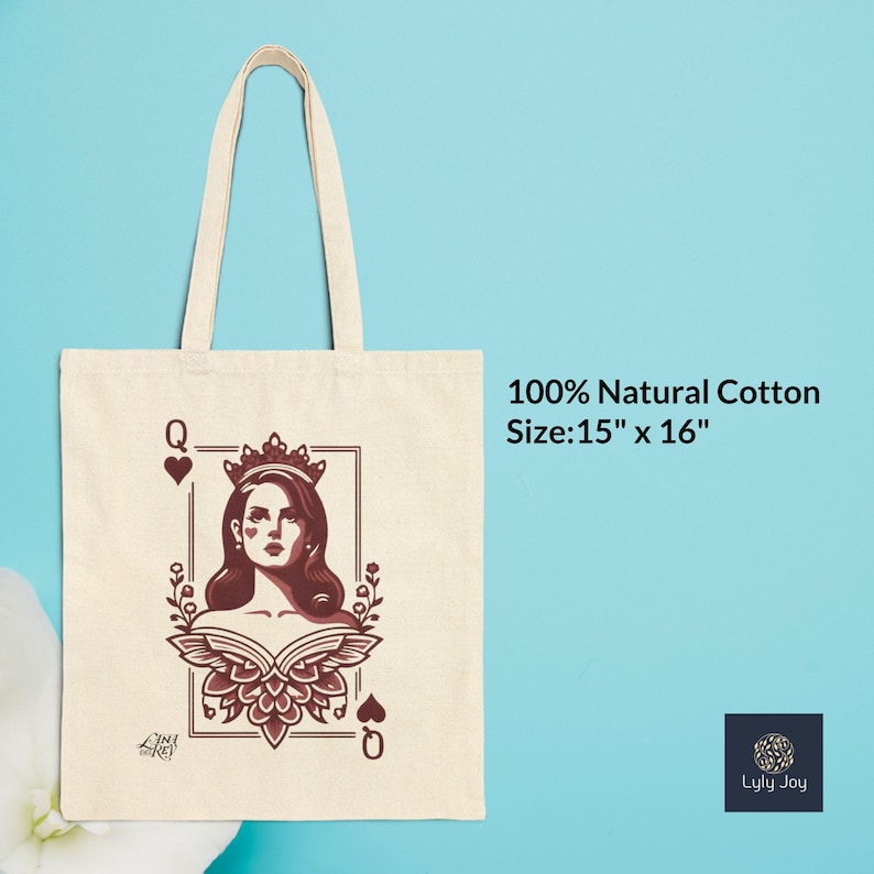 May include: A natural cotton tote bag featuring a Queen of Hearts design. The illustration is in shades of burgundy and brown, with the text "100% Natural Cotton" and "Size: 15" x 16"" printed on the bag. The bag has a light beige color and a handle.