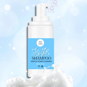 May include: White plastic bottle of lash shampoo with a light blue label. The label reads "Lash Shampoo Gentle Foam Cleanser" with a capacity of 60 ml / 1.7 oz. The bottle has a pump dispenser and is set against a light blue background.