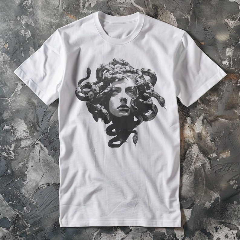 May include: White t-shirt with a black and white graphic print of Medusa, a mythical Greek figure with snakes for hair.