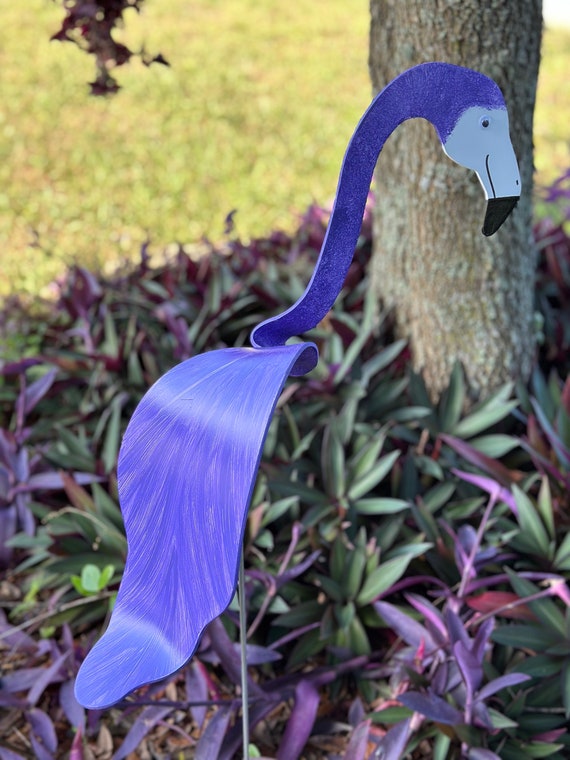 A purple flamingo bobbing/whirligig wind spinner with 23 favorites — cheerful kinetic garden art that actually moves with the breeze and earns its keep outdoors.