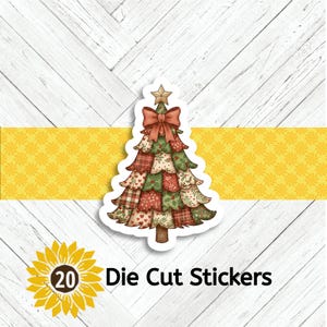 May include: A die-cut sticker featuring a Christmas tree design. The tree is adorned with a red bow and a star on top. The tree is made of patchwork patterns in red, green, and cream colors. The sticker is on a white background with a yellow stripe.