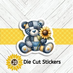 May include: Die cut sticker featuring a patchwork teddy bear holding a sunflower. The bear is primarily blue with star and plaid patterns. The sticker has a white border and the text "20 Die Cut Stickers".
