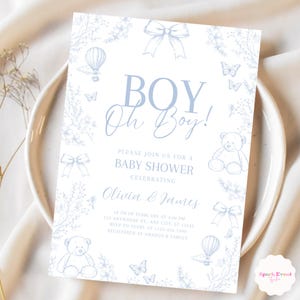 Op de afbeelding: Een blauwe en witte babyborrel uitnodiging met een bloemige rand. De uitnodiging zegt "BOY Oh Boy!" en bevat de tekst "Kom gezellig mee naar een babyborrel ter ere van Olivia & James".