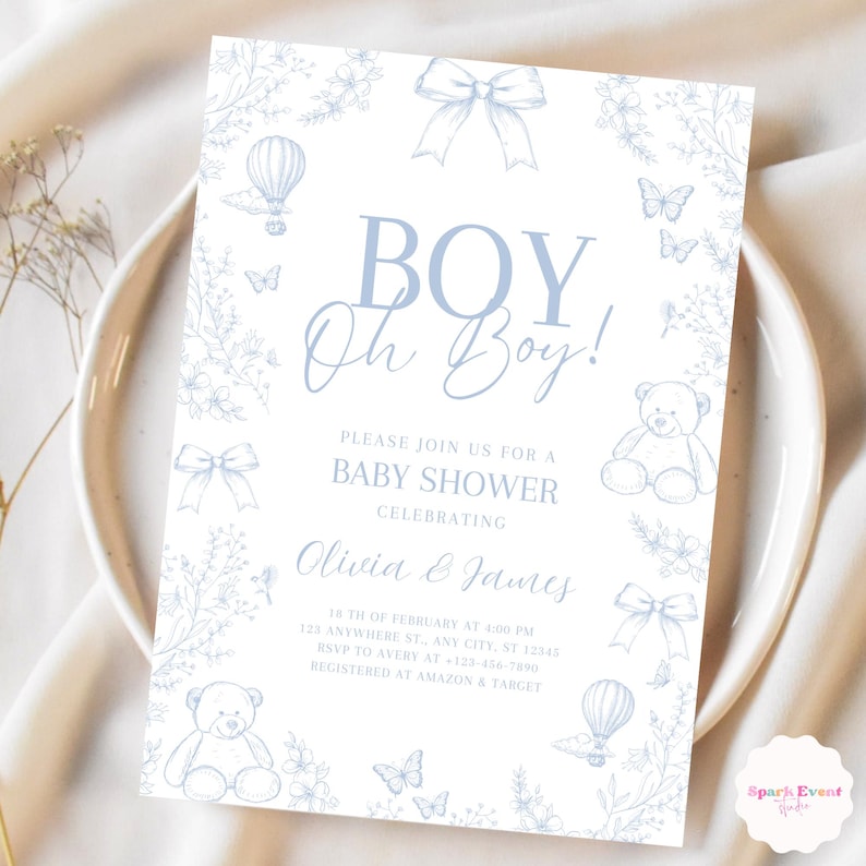 Op de afbeelding: Een blauwe en witte babyborrel uitnodiging met een bloemige rand. De uitnodiging zegt "BOY Oh Boy!" en bevat de tekst "Kom gezellig mee naar een babyborrel ter ere van Olivia & James".