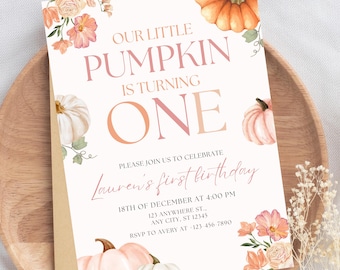 May include: A first birthday invitation with a pumpkin theme. The invitation features the text "Our Little Pumpkin is Turning One" in pink and peach hues. Watercolor pumpkins and floral accents decorate the card. Includes event details.