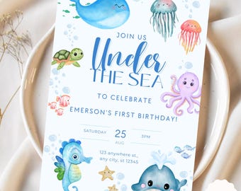 May include: Under the Sea themed first birthday party invitation with a blue whale, a purple octopus, a seahorse, a turtle, and a starfish. The invitation says "Join us Under the Sea to celebrate Emerson's First Birthday!"  Saturday, August 25th at 3pm. 123 anywhere st., any city, st 12345.