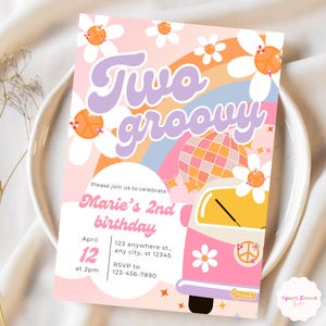 May include: A pink and yellow groovy themed birthday invitation for a 2nd birthday party. The invitation features a pink and yellow van with a peace sign and daisies. The text on the invitation reads "Two groovy" and "Marie's 2nd birthday".