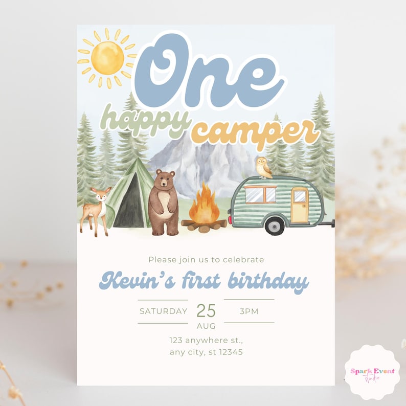 May include: A blue and yellow invitation for a first birthday party with a camping theme. The invitation features a cartoon sun, a bear, a tent, a camper, and a deer. The text reads "One happy camper" and "Kevin's first birthday". The date and time of the party are listed as "Saturday, August 25, 3 PM". The address is "123 anywhere st., any city, st 12345".
