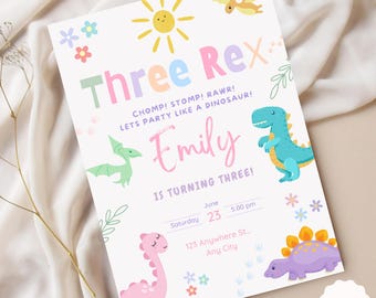 May include: A colorful dinosaur-themed birthday party invitation for a girl turning three. The invitation features a pink, blue, and green dinosaur, a sun, and flowers. The text on the invitation reads "Three Rex! CHOMP! STOMP! RAWR! LETS PARTY LIKE A DINOSAUR! Emily IS TURNING THREE!"  The invitation also includes the date, time, and location of the party.