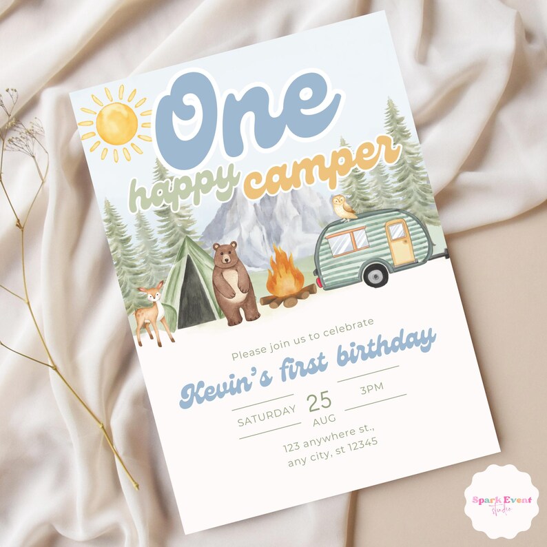 May include: A blue and yellow invitation for a first birthday party with a camping theme. The invitation features a cartoon sun, a bear, a tent, a campfire, a camper van, and a deer. The text on the invitation reads "One happy camper" and "Kevin's first birthday". The date and time of the party are listed as "Saturday, August 25th, 3PM".