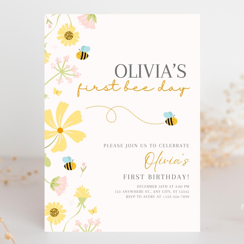May include: A cream-colored invitation with floral and bee illustrations. The text reads "OLIVIA'S first bee day" and "Olivia's FIRST BIRTHDAY!" with event details. Yellow and pink flowers and bees decorate the border.