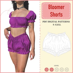 Puede incluir: Se muestra un conjunto de dos piezas de color púrpura, que consta de un top corto y unos bloomers. El top corto tiene mangas cortas abullonadas y un escote cuadrado. Los bloomers tienen un dobladillo con volantes. La imagen también incluye un diagrama de los bloomers y el texto "Bloomer Shorts".