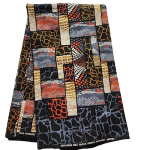 May include: Folded fabric with a vibrant geometric pattern. The design features rectangular blocks with animal print, dots, and other textures in black, orange, yellow, gray, and white. The fabric is labeled "VERITABLE WAX BLOCK PRINTS HITARGET".