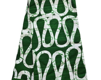 May include: A folded green and white patterned fabric. The fabric features a repeating design of white teardrop shapes with a cracked, textured appearance against a solid green background. The bottom right corner has gold text that reads "GOLD".