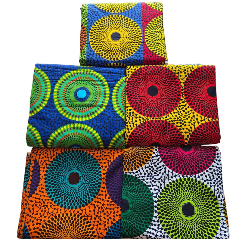 May include: Four pieces of colourful fabric with a circular pattern. The fabric is a mix of blue, green, yellow, red, orange, white, and black.